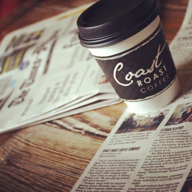 Coast Roast Coffee cup on newspaper article about CR Coffee