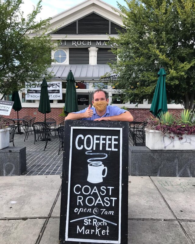 Kevin Pedeaux with Coast Roast Coffee sign