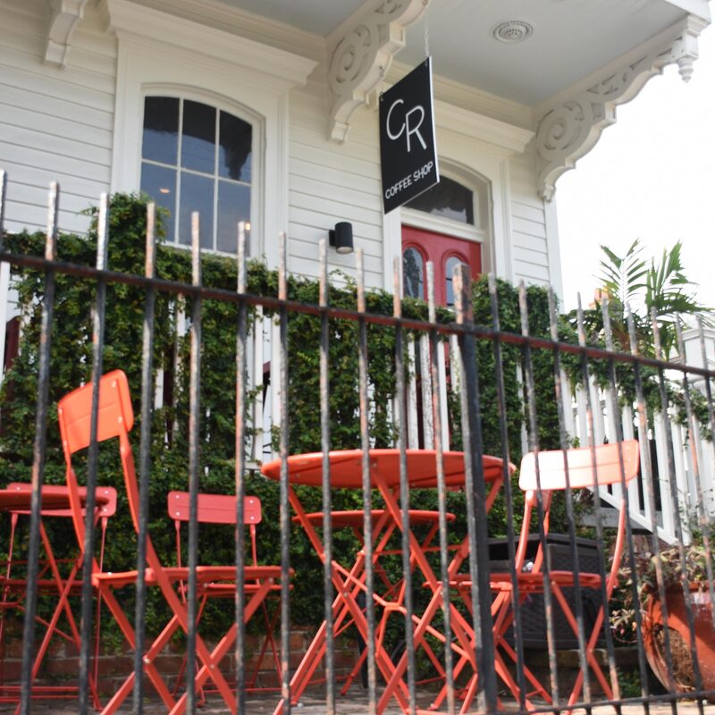 Magazine Street exterior with red patio chairs